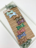 Set of 10 faux leather baby bows.