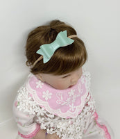 Set of 10 faux leather baby bows.
